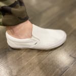 white slip on vans leather
